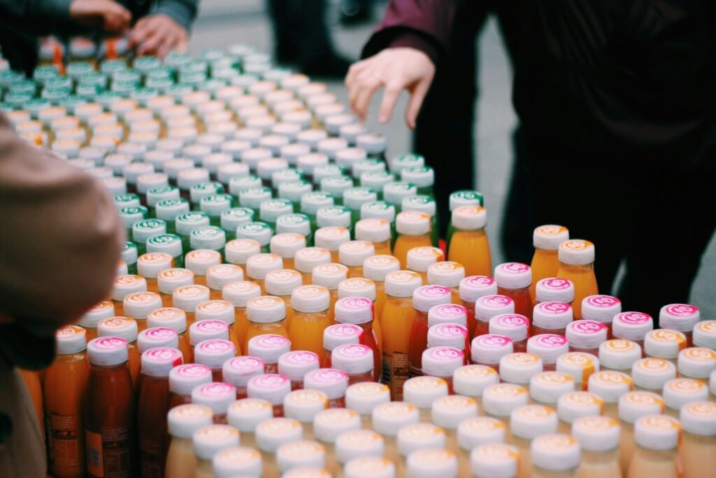 Rows of assorted small juice and drink bottles with different coloured caps