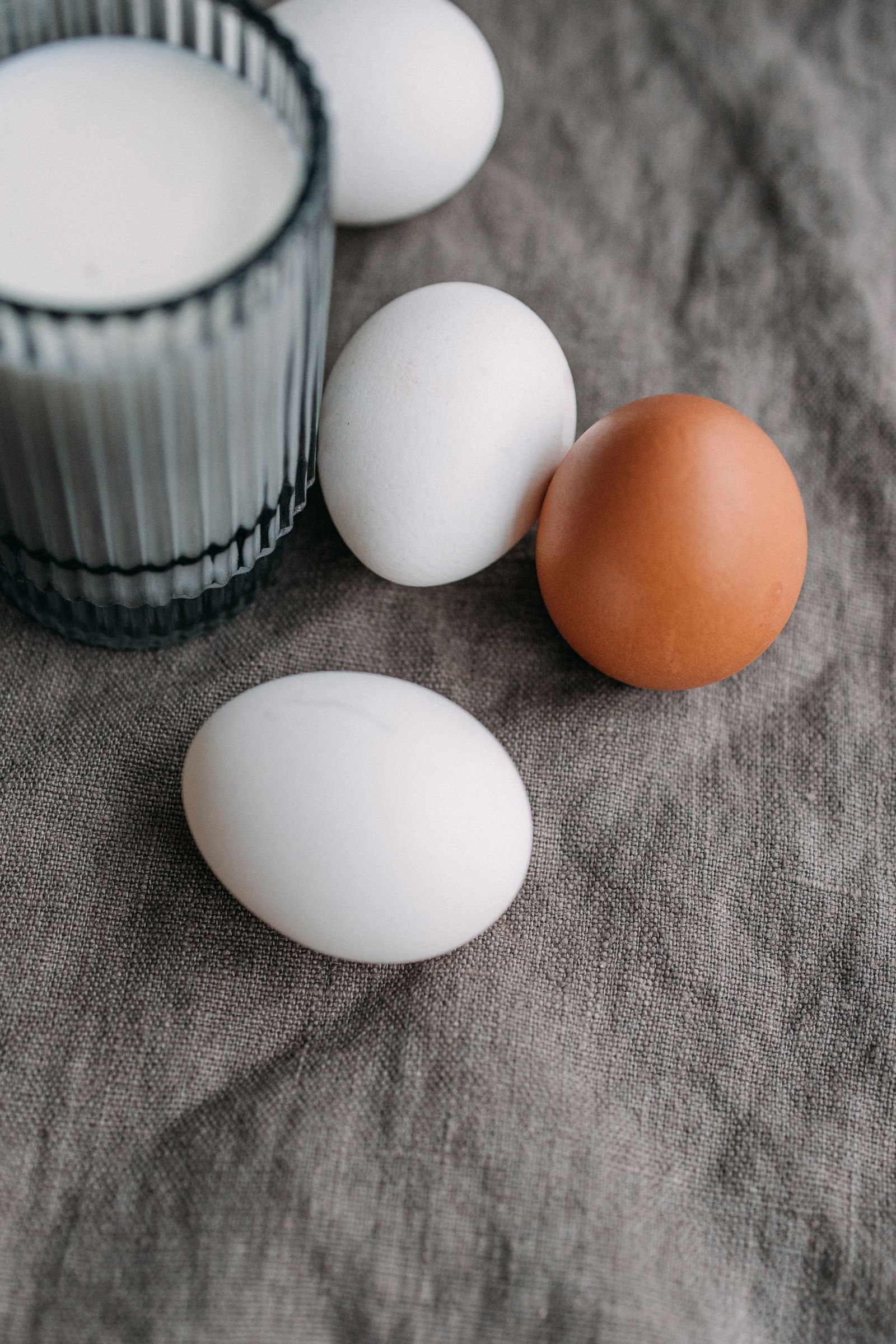 Eggs beside a glass of milk, foods many vegetarians eat but vegans avoid