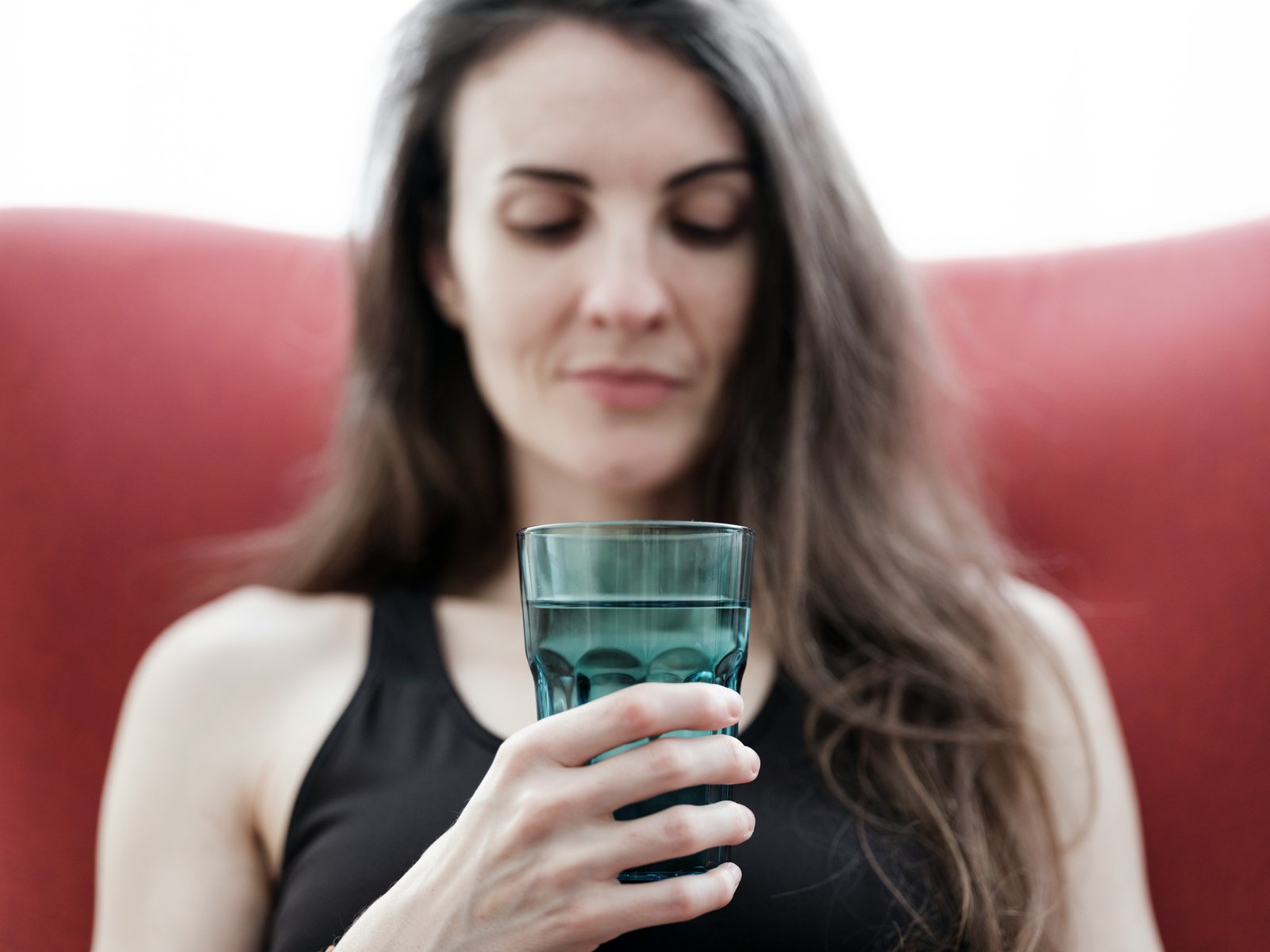 Person drinking a glass of water while unwell