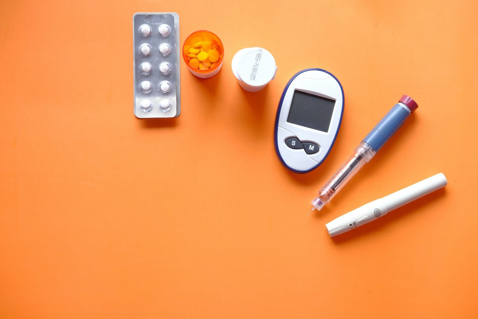 Blood glucose meter and a notebook on a table